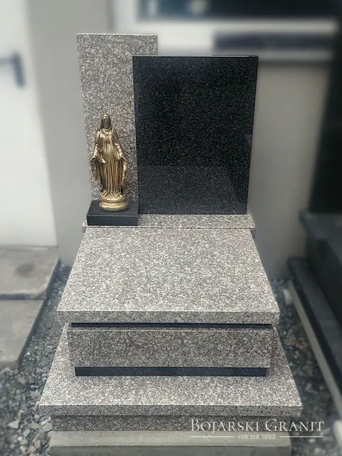 Nagrobek urnowy z granitów "Brąz Królewski" oraz "Impala" z figurą Matki Boskiej